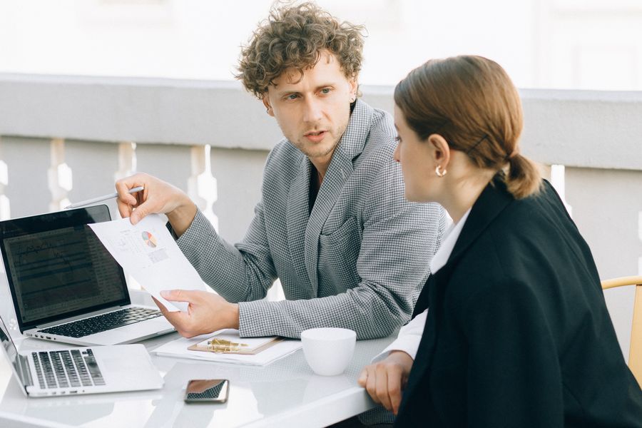 Two sales professionals reviewing deal details